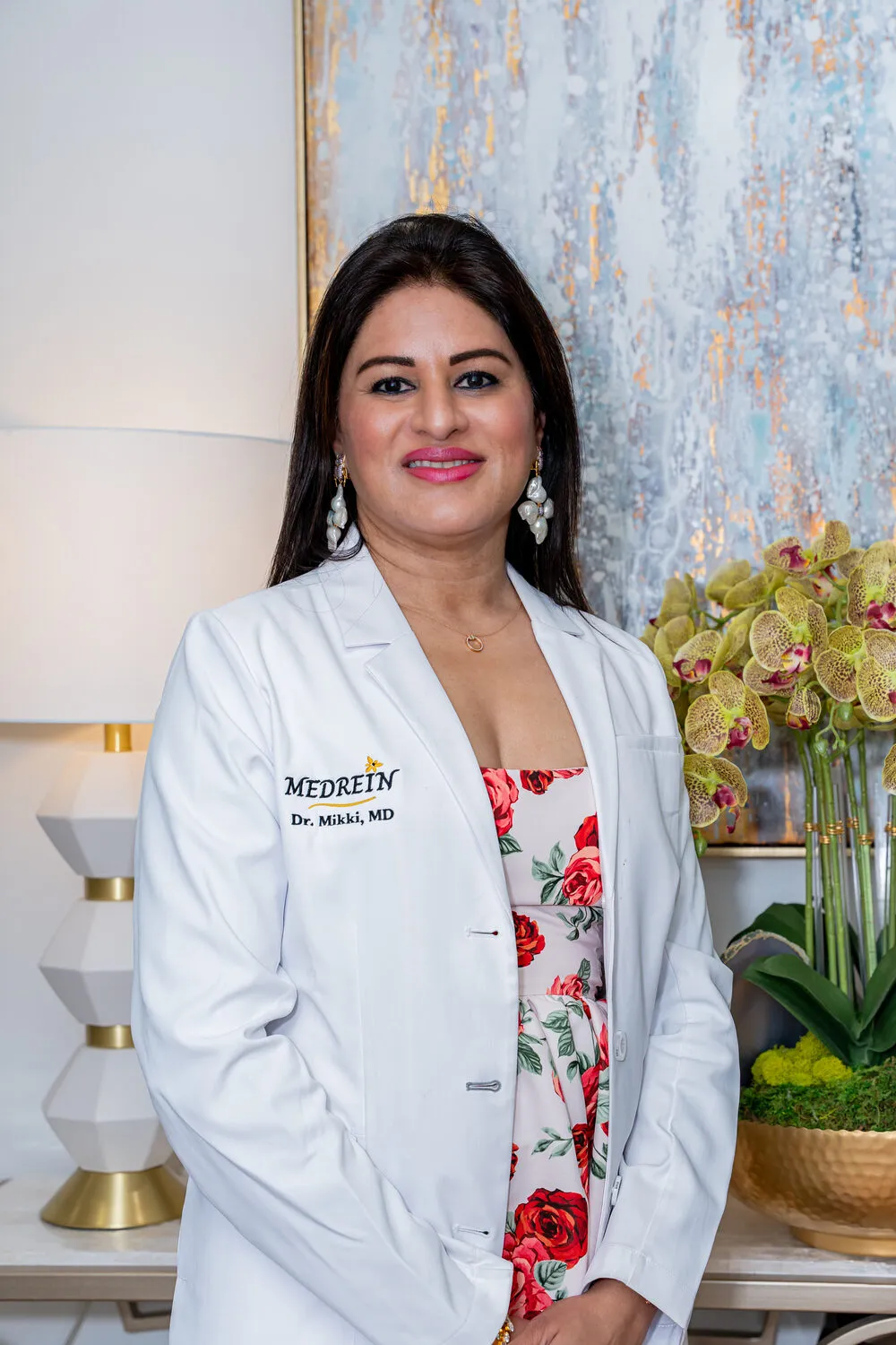 Dr. Haritha Mikkilineni, MD, founder and medical director of Medrein Health & Aesthetics, in her lab coat at the Southlake clinic