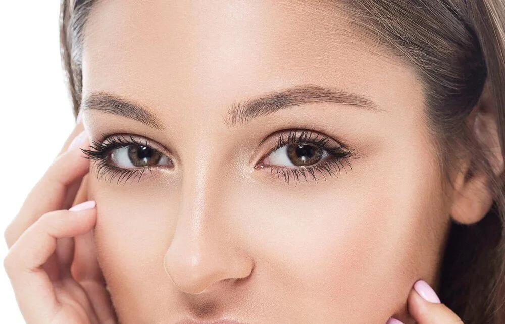 Close-up of a woman's eyes and brows showing eyeliner and eyebrow definition, the areas treated in cosmetic-tattoo removal